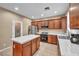 Functional kitchen featuring tile countertops, wooden cabinets, and stainless steel appliances at 9893 Santa Ponsa Ct, Las Vegas, NV 89178