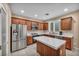 Well-lit kitchen features tile countertops, stainless steel appliances, and wooden cabinets at 9893 Santa Ponsa Ct, Las Vegas, NV 89178
