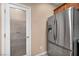 View of a stainless steel refrigerator and pantry with etched glass door in kitchen at 9893 Santa Ponsa Ct, Las Vegas, NV 89178