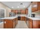 Well-lit kitchen with an island, stainless steel appliances, and wooden cabinets at 9893 Santa Ponsa Ct, Las Vegas, NV 89178