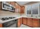Cozy kitchen features tile countertops, stainless steel appliances, and wood cabinetry at 9893 Santa Ponsa Ct, Las Vegas, NV 89178