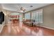 Spacious living room featuring hardwood floors, neutral tones, and a comfortable sofa by the window at 9893 Santa Ponsa Ct, Las Vegas, NV 89178