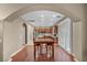 Open-concept living space with hardwood floors leading to the kitchen and dining area at 9893 Santa Ponsa Ct, Las Vegas, NV 89178
