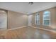 Open living room with hardwood floors, a front door, and transom windows for natural light at 9893 Santa Ponsa Ct, Las Vegas, NV 89178