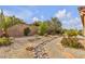 Backyard featuring desert landscaping, stone accents, and pathways for a tranquil outdoor experience at , Las Vegas, NV 89113
