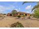 Serene backyard featuring desert landscaping including gravel, various trees, and a covered patio at , Las Vegas, NV 89113