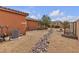 Low-maintenance backyard with rock landscaping, a stone walkway, and privacy fencing at , Las Vegas, NV 89113