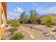 Backyard featuring desert landscaping, stone accents, and pathways for a tranquil outdoor experience at , Las Vegas, NV 89113