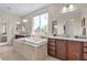 Luxurious bathroom featuring a soaking tub, dual vanities, and a large window with neighborhood views at , Las Vegas, NV 89113