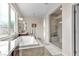 Bright bathroom featuring a glass shower, soaking tub, and vanity with natural light at , Las Vegas, NV 89113