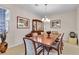 Formal dining room with wooden table, decorative china cabinet, and elegant chandelier lighting at , Las Vegas, NV 89113