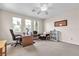 Bright office space with three large windows, a ceiling fan, and built-in shelves at , Las Vegas, NV 89113
