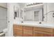 Bathroom features dual sinks, wood cabinets, and a shower at 101 Luna Way # 222, Las Vegas, NV 89145