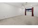 Large bedroom with neutral carpet, ceiling fan, and large window at 101 Luna Way # 222, Las Vegas, NV 89145