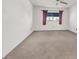 Bedroom with neutral walls and carpet, featuring a view of a window at 101 Luna Way # 222, Las Vegas, NV 89145
