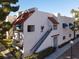Charming condo with a red tile roof, blue awnings, and well-maintained landscaping at 101 Luna Way # 222, Las Vegas, NV 89145