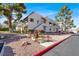 Charming two-story condo featuring stucco and tile, complemented by mature trees and gravel landscaping at 101 Luna Way # 222, Las Vegas, NV 89145