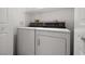 Small laundry room area featuring a stacked washer and dryer and white cabinets at 101 Luna Way # 222, Las Vegas, NV 89145