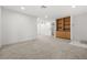 Open concept living room featuring plush carpet, built-in shelves, and neutral paint at 101 Luna Way # 222, Las Vegas, NV 89145
