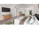 Bright main bedroom with a king bed, dresser, green chair, and access to the Primary bathroom at 101 Luna Way # 222, Las Vegas, NV 89145