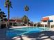 Community pool area with clear blue water, surrounded by palm trees and well-maintained landscaping at 101 Luna Way # 222, Las Vegas, NV 89145