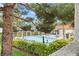 View of community pool with green foliage and shade trees at 101 Luna Way # 222, Las Vegas, NV 89145