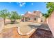 Wide backyard featuring low maintenance desert landscaping, covered patio, and privacy fence at 1033 Logan Patrick Dr, Henderson, NV 89052