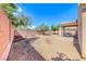 Large backyard area with desert landscaping, patio, and a privacy fence at 1033 Logan Patrick Dr, Henderson, NV 89052