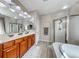 Ensuite bathroom with double sink vanity, separate shower, and soaking tub at 1033 Logan Patrick Dr, Henderson, NV 89052
