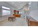 Charming dining area with a modern table set near the staircase and a window for natural light at 1033 Logan Patrick Dr, Henderson, NV 89052