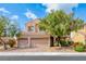 Charming two-story home with a well-manicured yard and a two-car garage at 1033 Logan Patrick Dr, Henderson, NV 89052