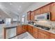 Open kitchen boasts granite countertops, stainless steel appliances, and wood cabinetry at 1033 Logan Patrick Dr, Henderson, NV 89052
