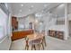 Well-lit kitchen featuring a table, wooden cabinets, granite countertops, and modern appliances at 1033 Logan Patrick Dr, Henderson, NV 89052