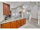 Bright kitchen with granite countertops, stainless steel appliances, and a view of the staircase at 1033 Logan Patrick Dr, Henderson, NV 89052