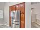 Kitchen area showcasing a stainless steel refrigerator and ample storage cabinets at 1033 Logan Patrick Dr, Henderson, NV 89052