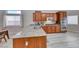 Spacious kitchen featuring granite countertops, wooden cabinets, and modern appliances at 1033 Logan Patrick Dr, Henderson, NV 89052