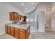 Kitchen featuring granite counters, wood cabinets, stainless steel appliances, and ample counter space at 1033 Logan Patrick Dr, Henderson, NV 89052