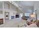 Spacious living room featuring a fireplace, vaulted ceiling, and access to the backyard at 1033 Logan Patrick Dr, Henderson, NV 89052