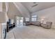 Bright living room with a vaulted ceiling, large windows, and sliding glass doors at 1033 Logan Patrick Dr, Henderson, NV 89052