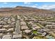 Community aerial showcasing desert landscape, green lawns, and houses with swimming pools, perfect for serene suburban living at 10470 Dove Meadow Way, Las Vegas, NV 89135