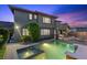 Backyard with a pool, hot tub, and lush landscaping at 10470 Dove Meadow Way, Las Vegas, NV 89135
