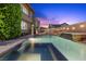 Stunning backyard with a pool, hot tub, and lush landscaping at 10470 Dove Meadow Way, Las Vegas, NV 89135