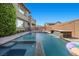 Backyard pool featuring a spa, and a soothing waterfall, nestled among lush greenery at 10470 Dove Meadow Way, Las Vegas, NV 89135