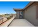 A cozy balcony with black metal railing, offering an outdoor space for relaxation and beautiful views at 10470 Dove Meadow Way, Las Vegas, NV 89135