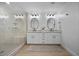 Stylish bathroom features dual sinks with granite counters, modern lighting, and a glass-enclosed shower at 10470 Dove Meadow Way, Las Vegas, NV 89135