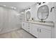 Stylish bathroom with a glass shower, double sinks, granite countertops, and modern lighting at 10470 Dove Meadow Way, Las Vegas, NV 89135