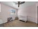 Bright bedroom featuring a crib, a bookshelf and a window letting in natural light at 10470 Dove Meadow Way, Las Vegas, NV 89135