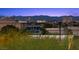 Picturesque city view captures a nighttime panorama of the illuminated cityscape against a backdrop of shadowy mountains at 10470 Dove Meadow Way, Las Vegas, NV 89135