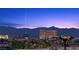 Breathtaking city view showcasing illuminated buildings against a twilight sky and the distant mountain range at 10470 Dove Meadow Way, Las Vegas, NV 89135