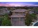 Beautiful two-story home featuring a three-car garage, lush landscaping and picturesque sunset views at 10470 Dove Meadow Way, Las Vegas, NV 89135